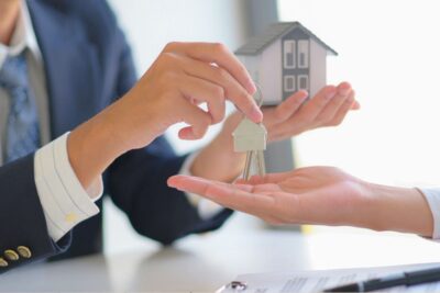Real estate agent handing over keys